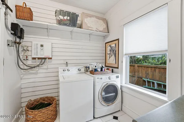 a view of a house with a yard and furniture