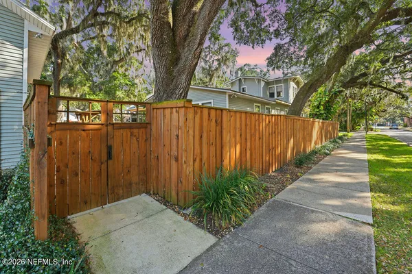 a backyard of a house with lots of green space and fountain