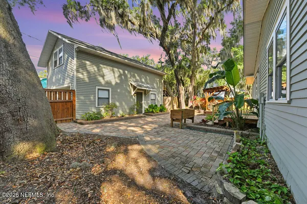 a view of a small house with yard