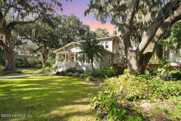 a front view of a house with a yard table and chairs