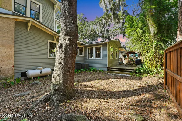 a living room with furniture a rug and kitchen view