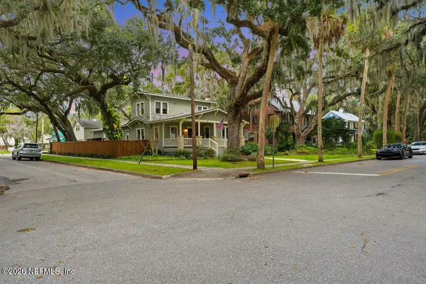 a living room with furniture fireplace and wooden floor