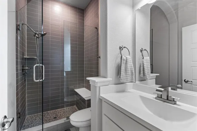 a bathroom with a sink toilet and shower