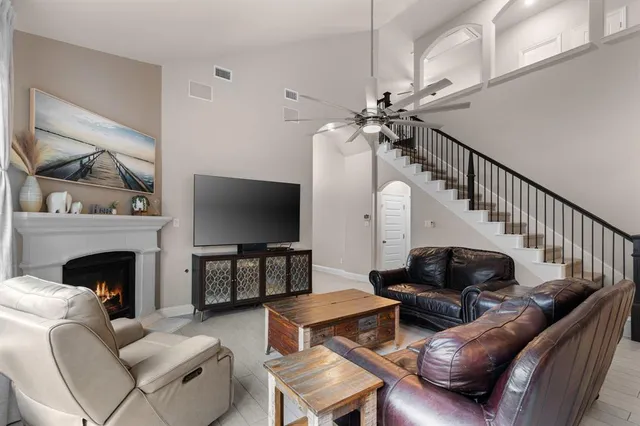 a living room with furniture ceiling fan and a fireplace