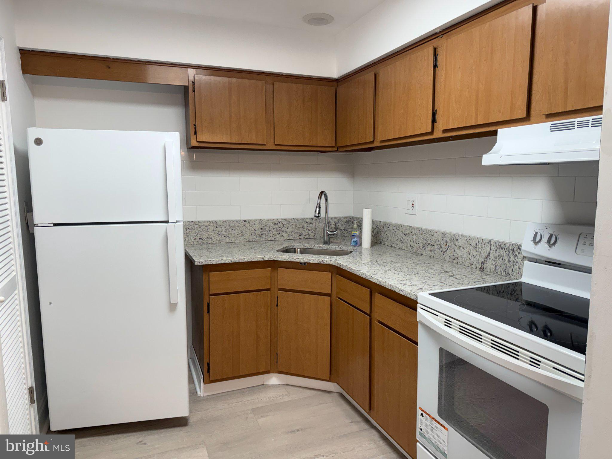512 Stidman Drive, Unit D3 Springfield, PA 19064 - Photo 7 of 14 Modern kitchen with warm wood tones.