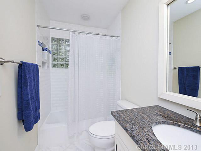 4216 Murrayhill Road Charlotte, NC 28209 - Photo 14 of 16 a bathroom with a granite countertop sink toilet and shower