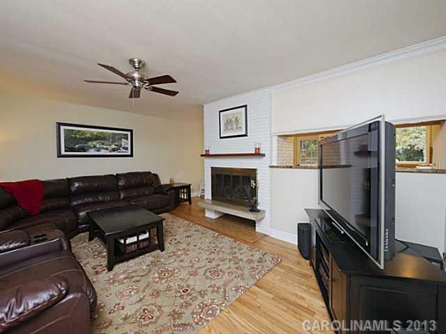 4216 Murrayhill Road Charlotte, NC 28209 - Photo 3 of 16 a living room with furniture a rug and a flat screen tv