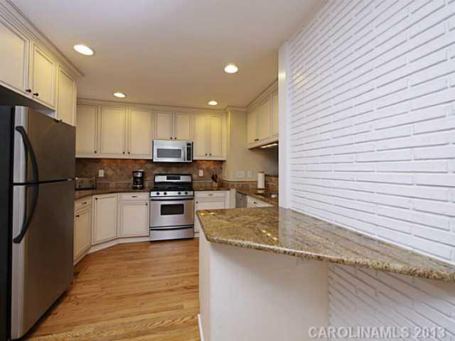 4216 Murrayhill Road Charlotte, NC 28209 - Photo 7 of 16 a kitchen with stainless steel appliances granite countertop a refrigerator a stove a sink and a microwave