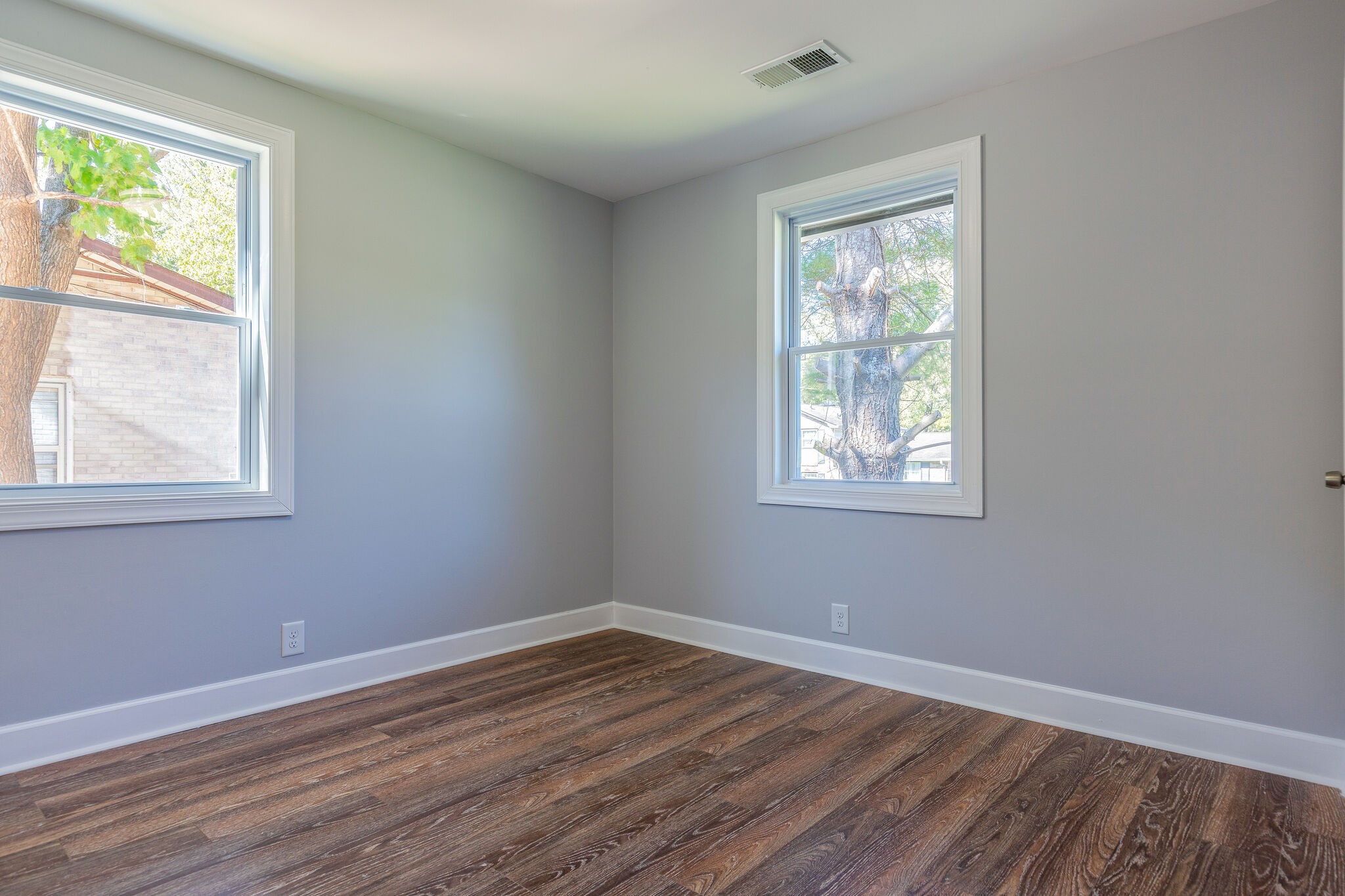 75 Benzing Road Antioch, TN 37013 - Photo 14 of 23 a view of an empty room with wooden floor and a window