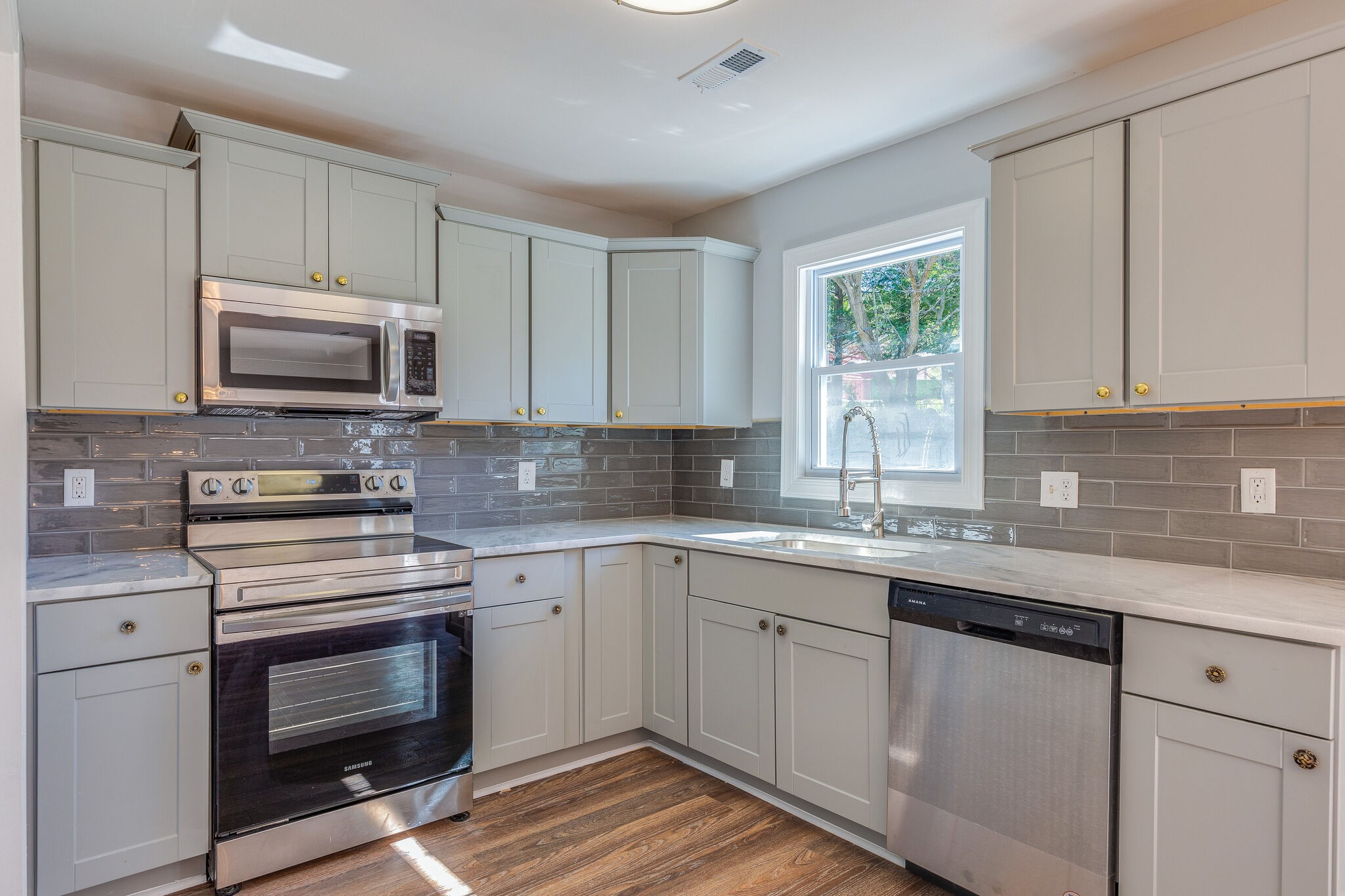 75 Benzing Road Antioch, TN 37013 - Photo 6 of 23 a kitchen with granite countertop a stove a sink and a microwave