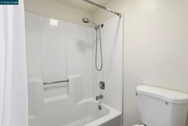 a bathroom with a shower and a toilet