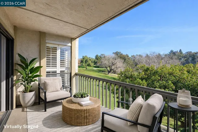 a view of a patio with couches chair and potted plants