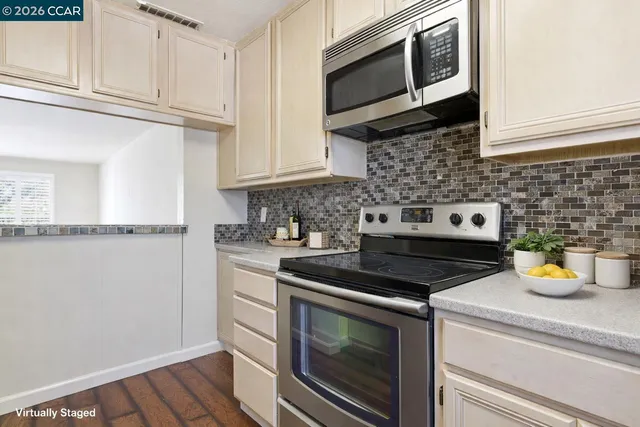 a kitchen with stainless steel appliances granite countertop a stove and a microwave