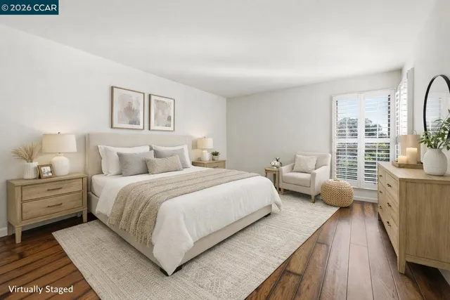 a bedroom with bed and wooden floor