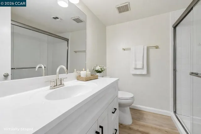 a bathroom with a sink toilet and a mirror