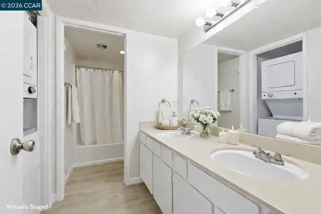 a bathroom with double vanity sinks and a mirror