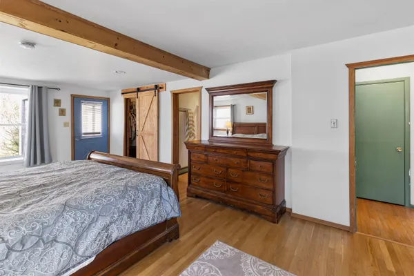 a bedroom with a large bed and a closet