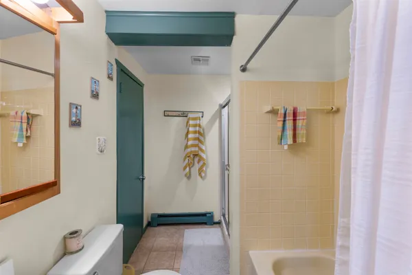 a bathroom with a bathtub a sink and a mirror