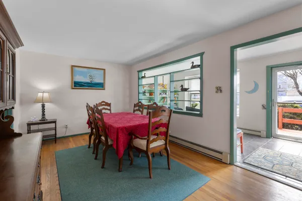 a view of a dining room with furniture and wooden floor