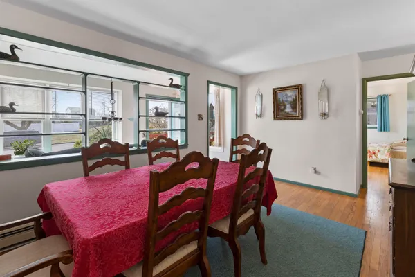 a living room with furniture a dining table and kitchen view