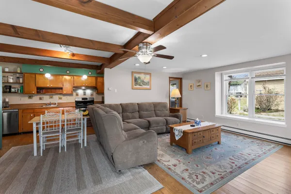 a living room with furniture and painting on the wall