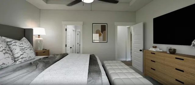 a bedroom with a bed and a flat tv screen on dresser