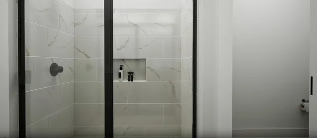 a bathroom with a glass shower door