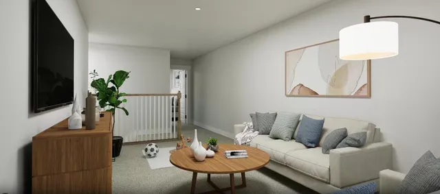 a living room with furniture and a potted plant