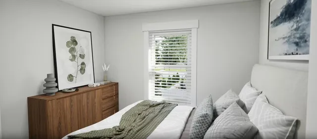 a bedroom with a bed and a window