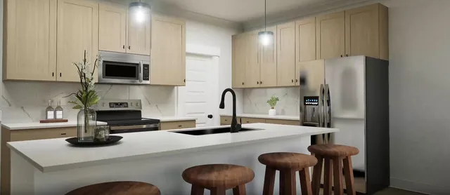 a kitchen with cabinets and chairs