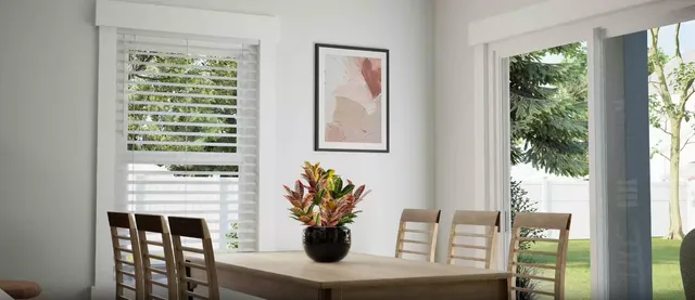 a view of a dining room with furniture and a window