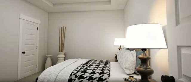 a bedroom with a bed and a lamp