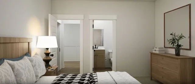 a bedroom with a bed and a lamp