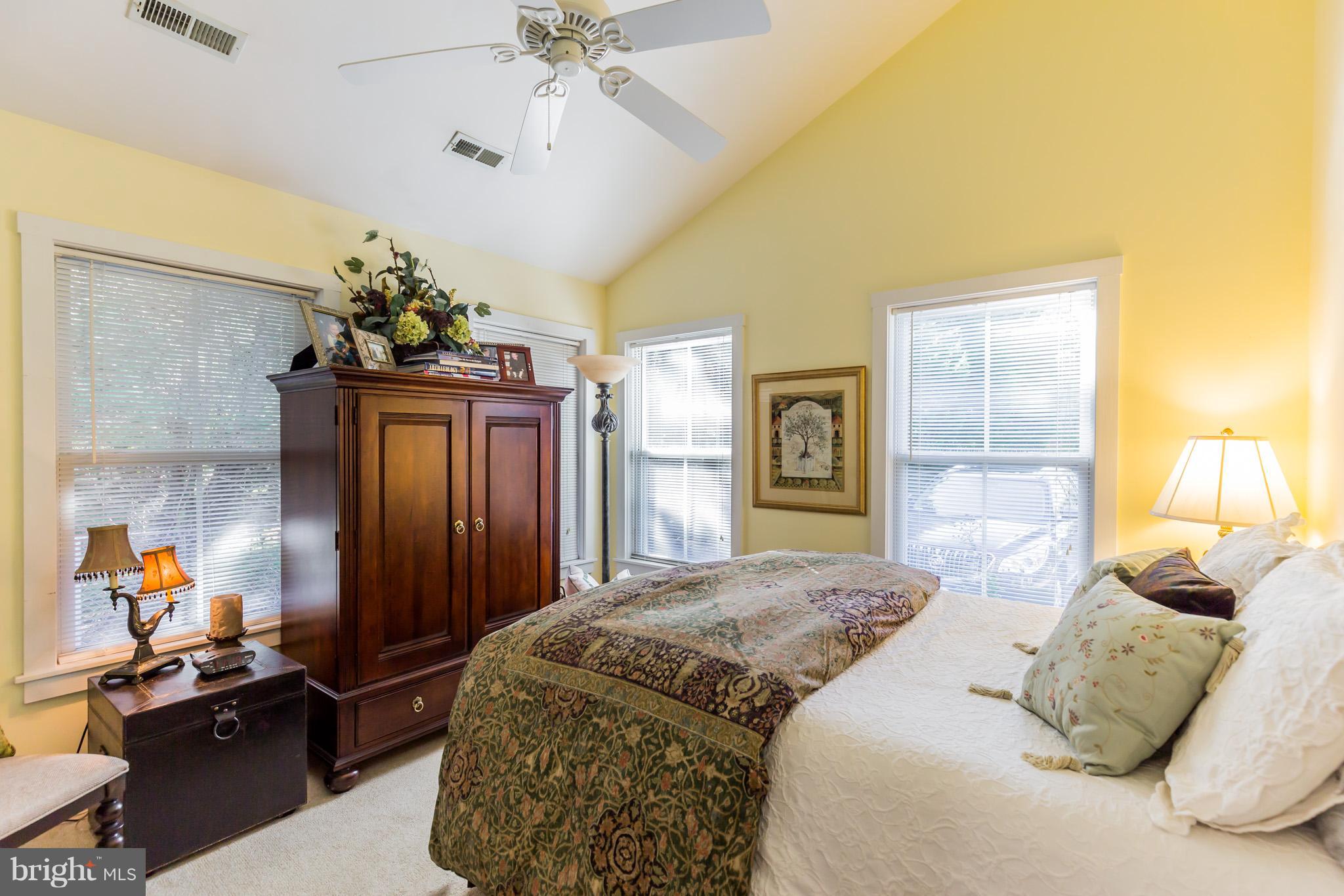 6155 Hallowing Point Road Prince Frederick, MD 20678 - Photo 17 of 29 a bedroom with a bed and a chandelier