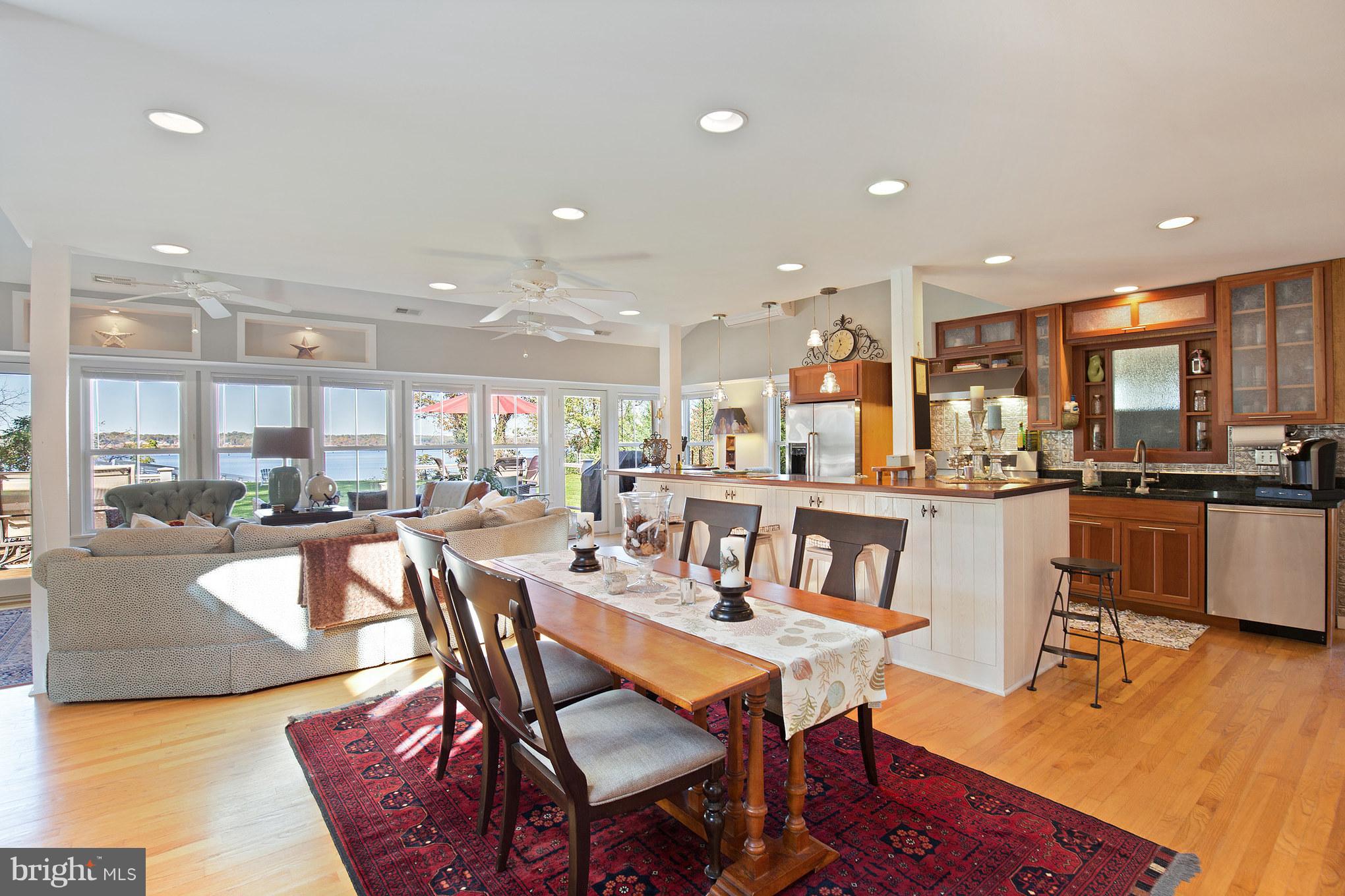 6155 Hallowing Point Road Prince Frederick, MD 20678 - Photo 7 of 29 a dining room with stainless steel appliances a dining table chairs and kitchen view