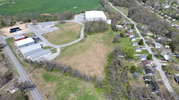 an aerial view of a house with a yard and trees