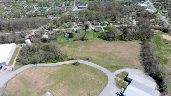 an aerial view of a house with a yard and lake
