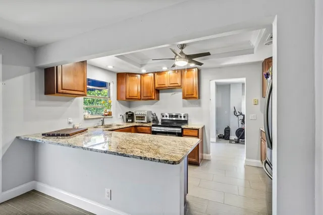 a kitchen with a refrigerator a sink and a stove