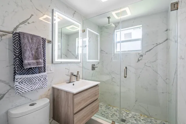 a bathroom with a sink toilet and shower