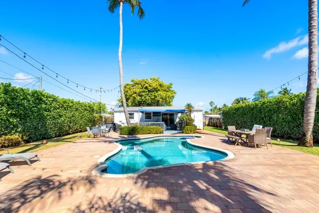 a view of a backyard with sitting area