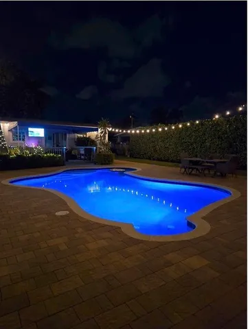 a view of swimming pool with outdoor seating
