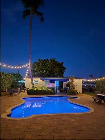 a view of a swimming pool with an outdoor seating