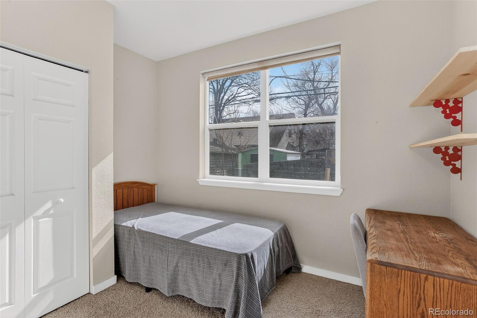 1902 Grove Street Boulder, CO 80302 - Photo 26 of 38 a bedroom with a bed and wooden floor