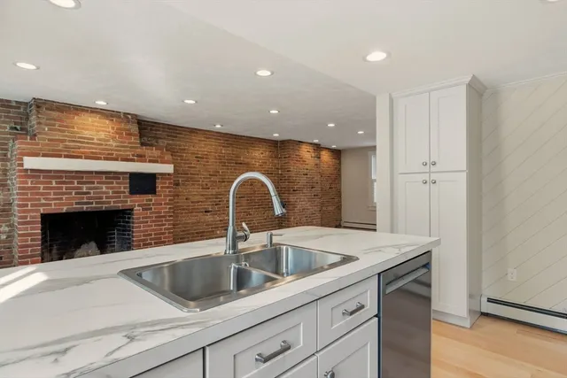 a kitchen with a sink and a refrigerator