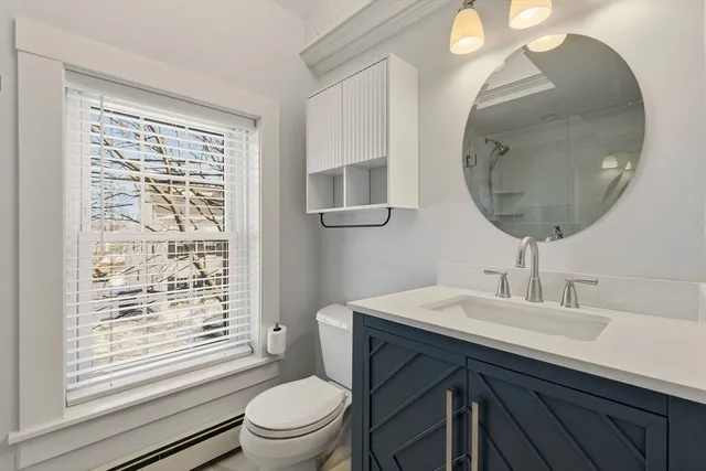 a bathroom with a sink a toilet and a mirror