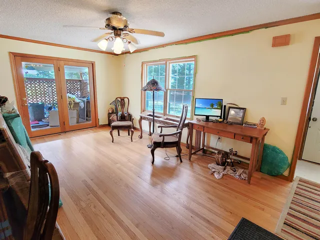 a living room with furniture a flat screen tv and a table