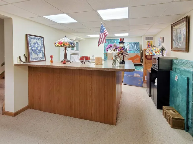 a room with furniture a rug and a chandelier