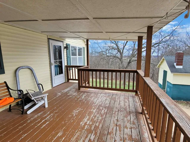 a view of a house with a yard and large tree