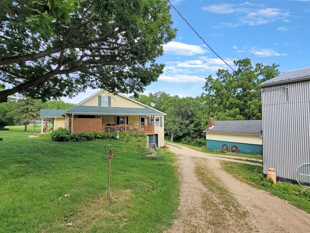 a view of a grassy field with trees