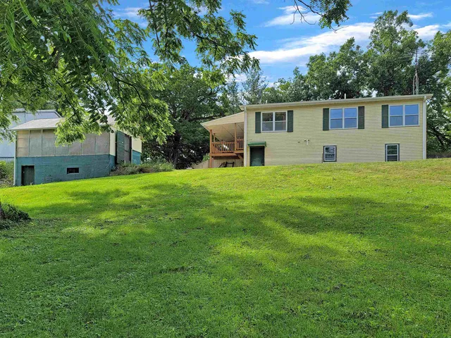 a house that has a big yard with large trees